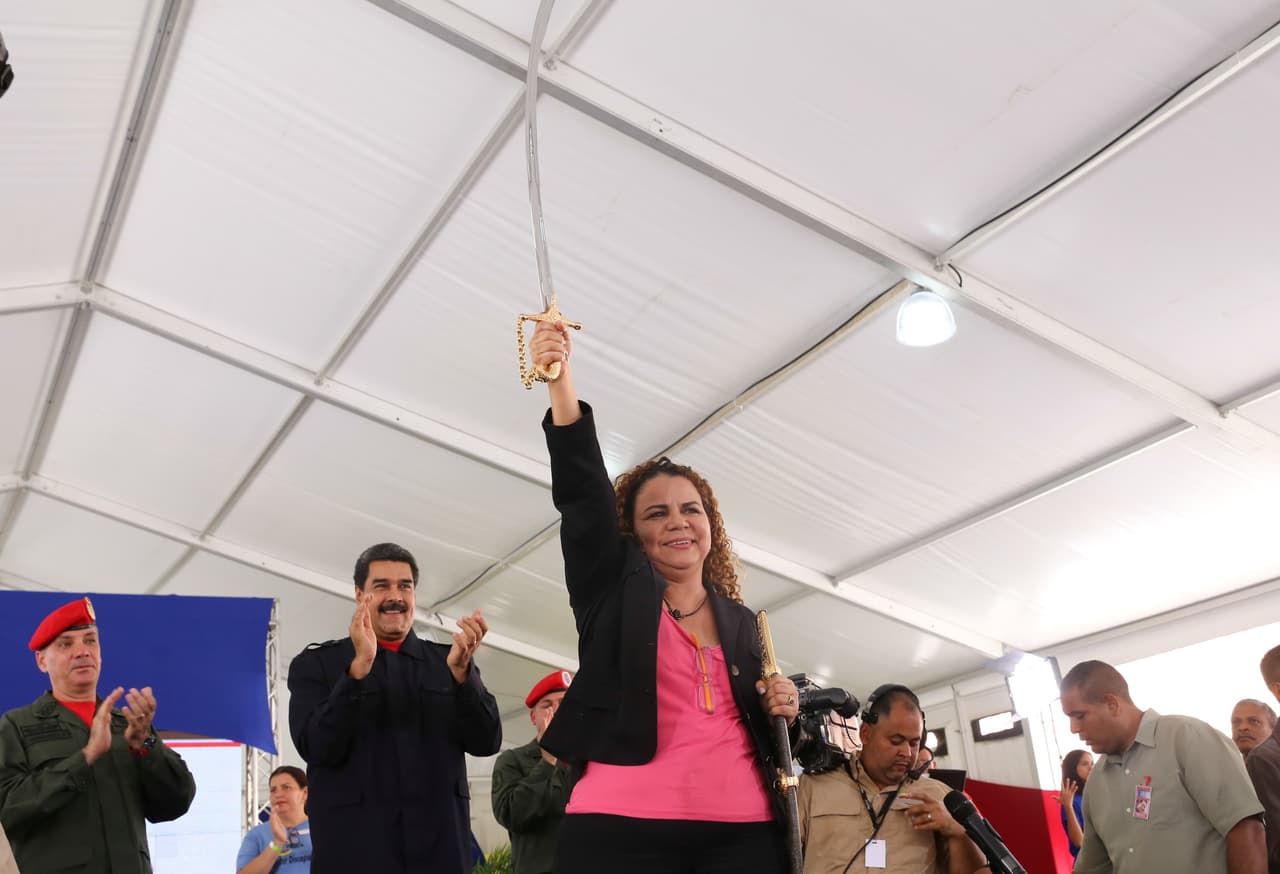 Iris Varela (C), former Venezuela's Prisons Minister, holds a replica of the sword of national hero Simon Bolivar next to Venezuela's President Nicolas Maduro (2nd L) during a ceremony in Caracas, Venezuela July 26, 2017.
