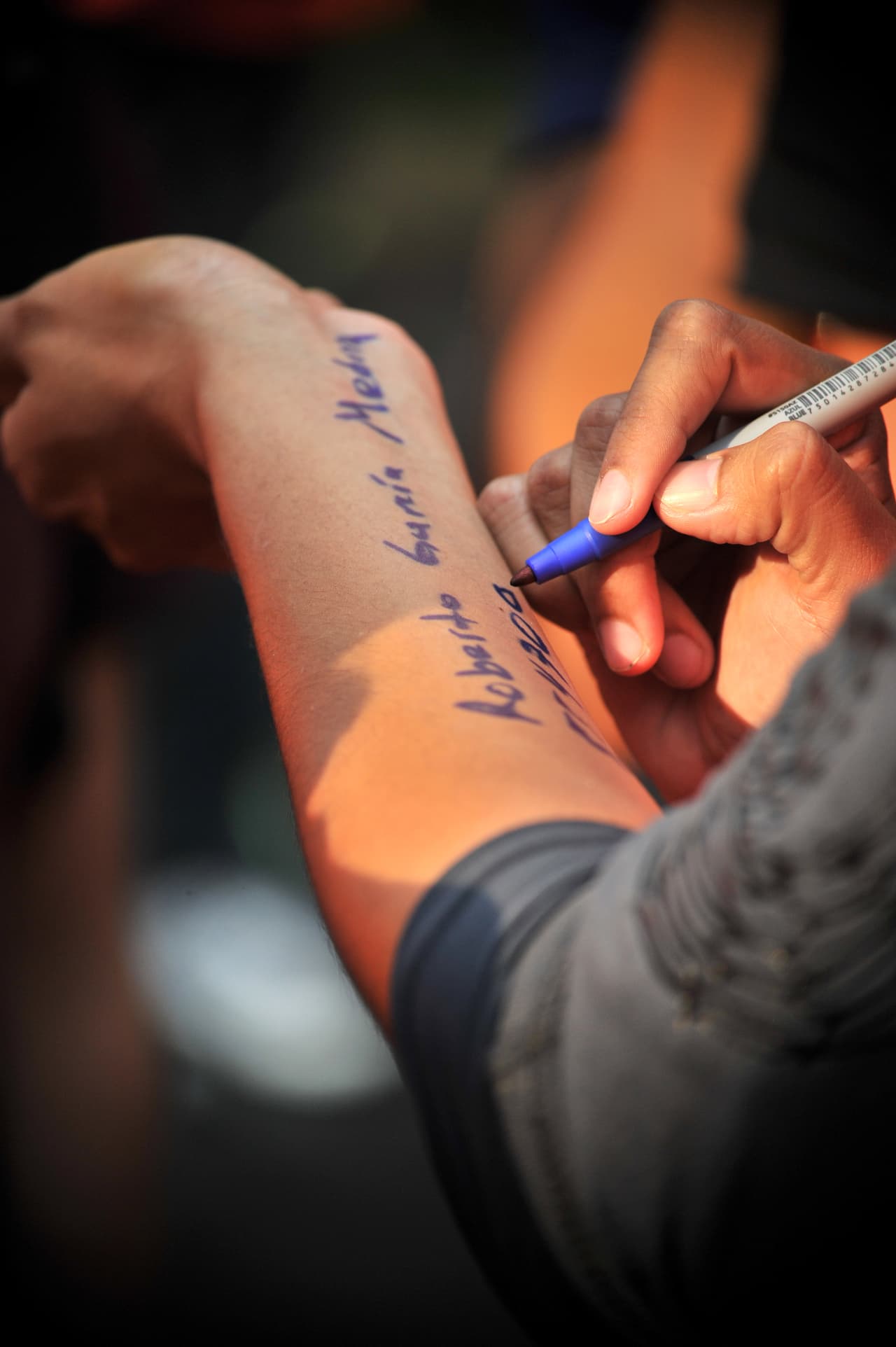 Volunteer rescue workers write their blood type and contact information on their arms, in case something happens to them, before taking part in the search for survivors and bodies in Mexico City on September 21, 2017, two days after a strong quake hit central Mexico. A powerful 7.1 earthquake shook Mexico City on Tuesday, causing panic among the megalopolis' 20 million inhabitants on the 32nd anniversary of a devastating 1985 quake. / AFP PHOTO / ROCIO VAZQUEZ (Photo credit should read ROCIO VAZQUEZ/AFP/Getty Images)