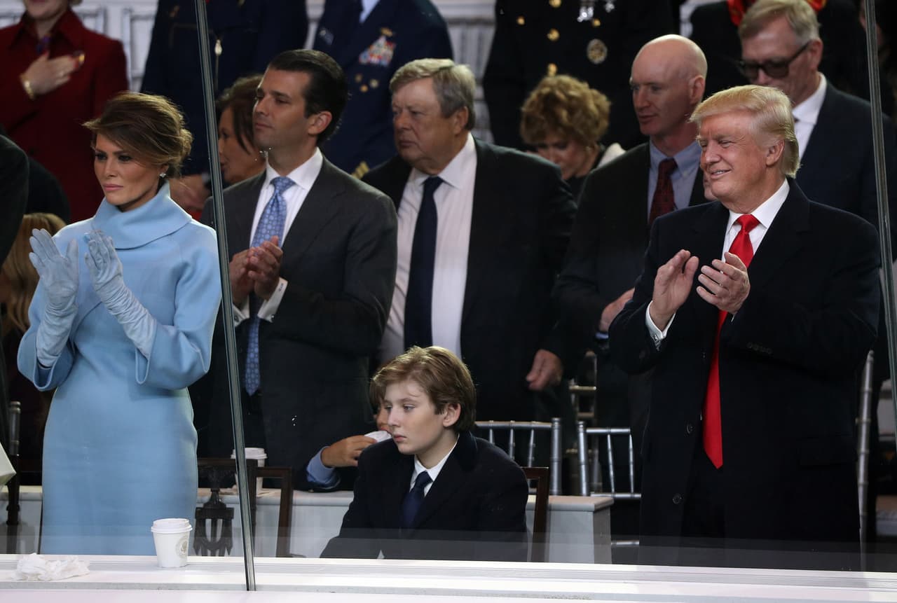 WASHINGTON, DC - JANUARY 20: (L-R) First lady Melania Trump, Barron Trump and U.S. President Donald Trump watch the Inaugural Parade from the main reviewing stand in front of the White House on January 20, 2017 in Washington, DC. Donald J. Trump was sworn in today as the 45th president of the United States. (Photo by Patrick Smith/Getty Images)