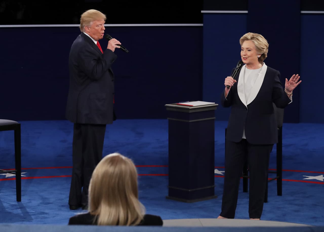 ST LOUIS, MO - OCTOBER 09: Democratic presidential nominee former Secretary of State Hillary Clinton (R) speaks as Republican presidential nominee Donald Trump looks on during the town hall debate at Washington University on October 9, 2016 in St Louis, Missouri. This is the second of three presidential debates scheduled prior to the November 8th election. (Photo by Chip Somodevilla/Getty Images)