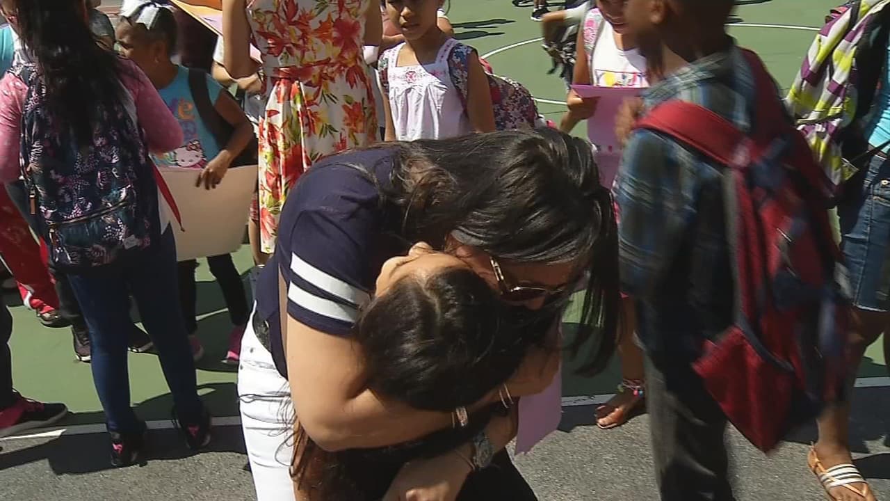 Arlette and her mother Clotilde hug during the last day of class.