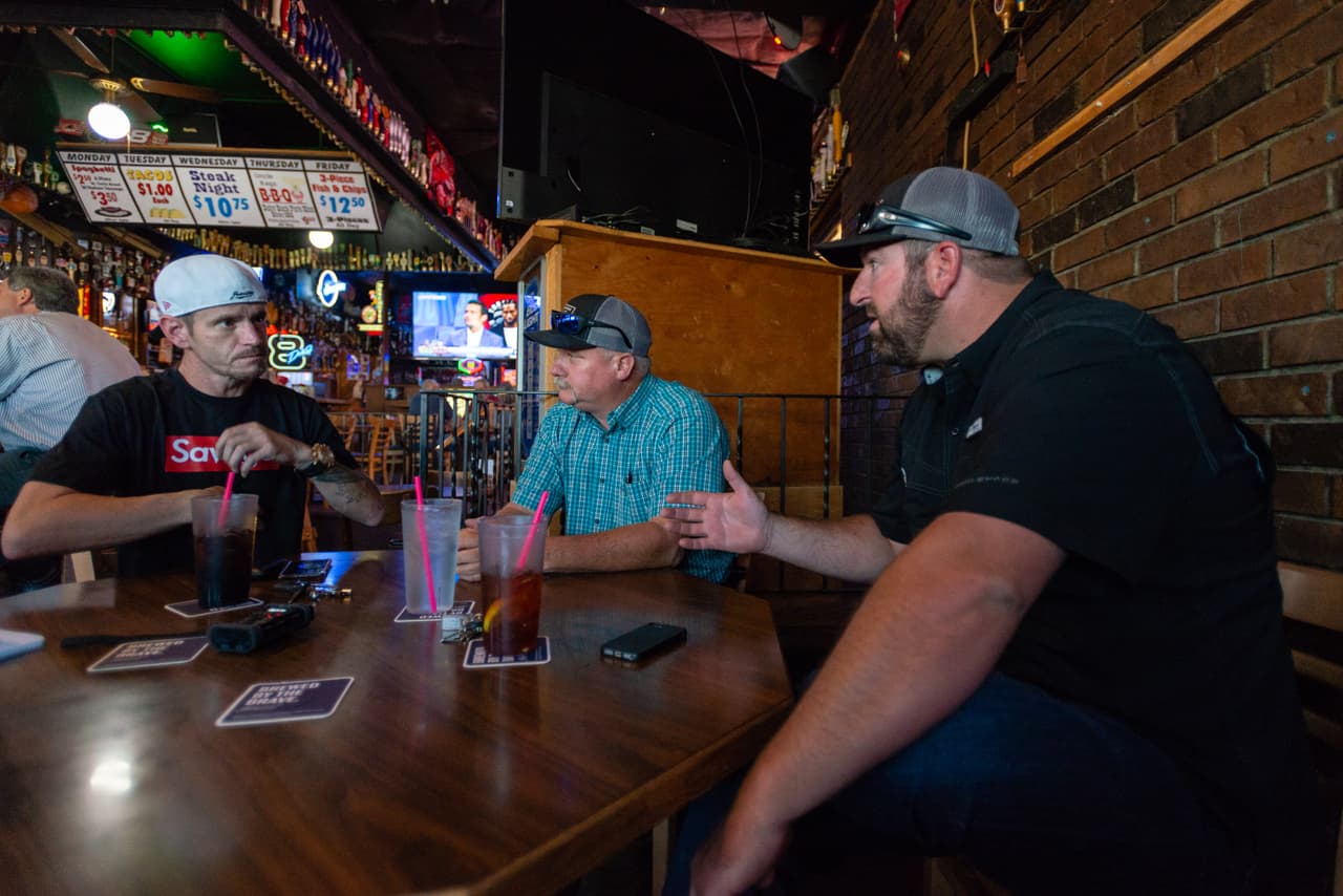 Jimmy Sullivan meets with Matt Eleazer and Mike Titus at a local pub in Portland, Ore., on July 25, 2018. Eleazer and Titus offer to find Sullivan a job if he can pass a drug test. “Matt and Mike were the first ones who cared enough,” says Sullivan. “None of my employers gave a shit enough to even ask.” (Heidi de Marco/KHN)