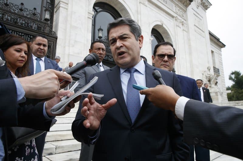 Honduran President Juan Orlando Hernandez speaks to the reporters as he leaves a meeting at the Organization of American States, in Washington, August 13, 2019.