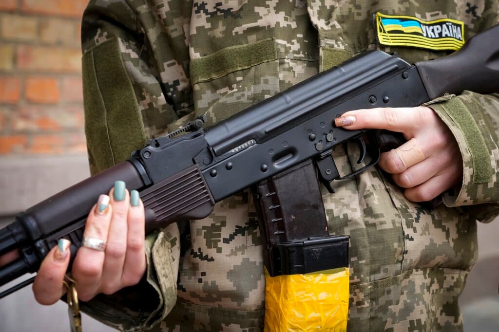 Una mujer que se ha unido a las fuerzas civiles de apoyo a las tropas ucranianas en Kiev sostiene en sus manos un rifle Kalashnikov.
