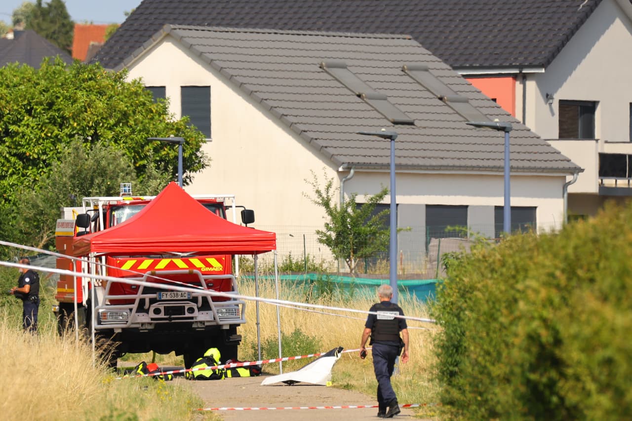 Police officer stands near the site where a skydiving plane crashed in Tomblaine northeastern France, killing all 11 people on board, Sunday, June 28, 2026. (AP Photo/Antonin Utz)
