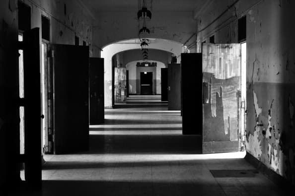 A hallway leading to patients' rooms is seen in the main building of the Trans-Allegheny Lunatic Asylum in Weston, West Virginia on August 24, 2013. Later called the Armand Auclerc Weston State Hospital, the Kirkbride psychiatric hospital was operated from 1864 until 1994 by the US government. Originally designed to hold 200 patients, numbers swelled to over 2,000 in the 1950s. It was forcibly closed in 1994 due to changes in treatments of patients. The now privately owned building complex is opened to tours and other money raising events, the proceeds of which go to the restoration and preservation of this historic landmark. AFP PHOTO / Eva Hambach (Photo credit should read EVA HAMBACH/AFP/Getty Images)