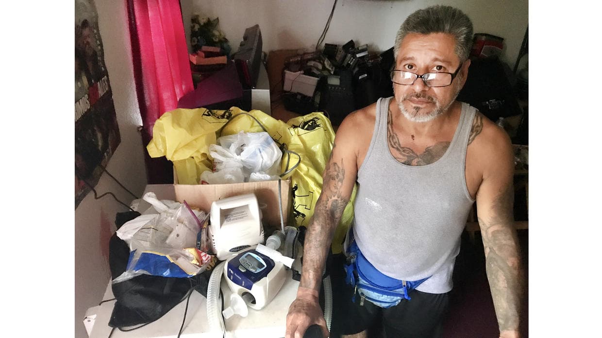 Mexican America Ricardo Laredo with the two machines that help him breathe.