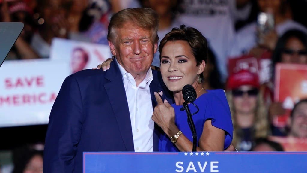 FILE - Arizona Republican gubernatorial candidate Kari Lake, right, speaks as former President Donald Trump listens during a rally, Oct. 9, 2022, in Mesa, Ariz. While vice presidential candidates typically aren't tapped until after a candidate has locked down the nomination, Trump's decisive win in the Iowa caucuses and the departure of Florida Gov. Ron DeSantis from the race has only heightened what had already been a widespread sense of inevitability. Lake is considered a close ally of the former president who is among those being considered for the job. (AP Photo/Matt York, File)