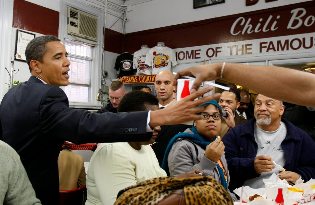 FILE-This Jan. 10, 2009 file photo shows then President-elect Barack Obama eating with Washington Mayor Adrian Fenty, center, at Ben's Chili Bowl in Washington. Pizza in St. Louis, pancakes in Pittsburgh. A burger with spicy mustard or a chili half-smoke in D.C., soul food in Chicago. Call it the mouth that roared: Our president eats something and the world wants to eat it, too. (AP Photo/Gerald Herbert,File)