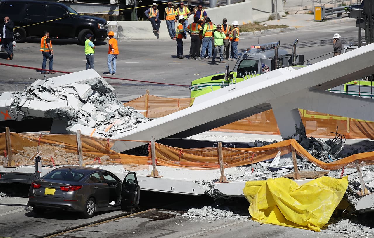 MIAMI, FL - MARCH 15: Miami-Dade Fire Rescue Department personel and other rescue units work at the scene where a pedestrian bridge collapsed a few days after it was built over southwest 8th street allowing people to bypass the busy street to reach Florida International University on March 15, 2018 in Miami, Florida. Reports indicate that there are an unknown number of fatalities as a result of the collapse, which crushed at least five cars. (Photo by Joe Raedle/Getty Images)
