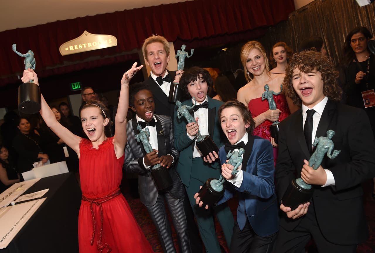 LOS ANGELES, CA - JANUARY 29: (L-R) Actors Millie Bobby Brown, Caleb McLaughlin, Matthew Modine, Finn Wolfhard, Noah Schnapp, Cara Buono and Gaten Matarazzo, winners of the Outstanding Ensemble in a Drama Series award for 'Stranger Things,' pose during The 23rd Annual Screen Actors Guild Awards at The Shrine Auditorium on January 29, 2017 in Los Angeles, California. 26592_016 (Photo by Emma McIntyre/Getty Images for TNT)