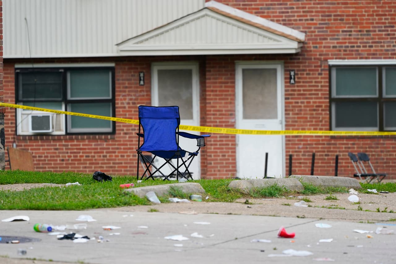 A chair remains upright in the area of a mass shooting incident in the Southern District of Baltimore, Sunday, July 2, 2023. Police say a number of people were killed and dozens were wounded in a mass shooting that took place during a block party just after midnight. (AP Photo/Julio Cortez)