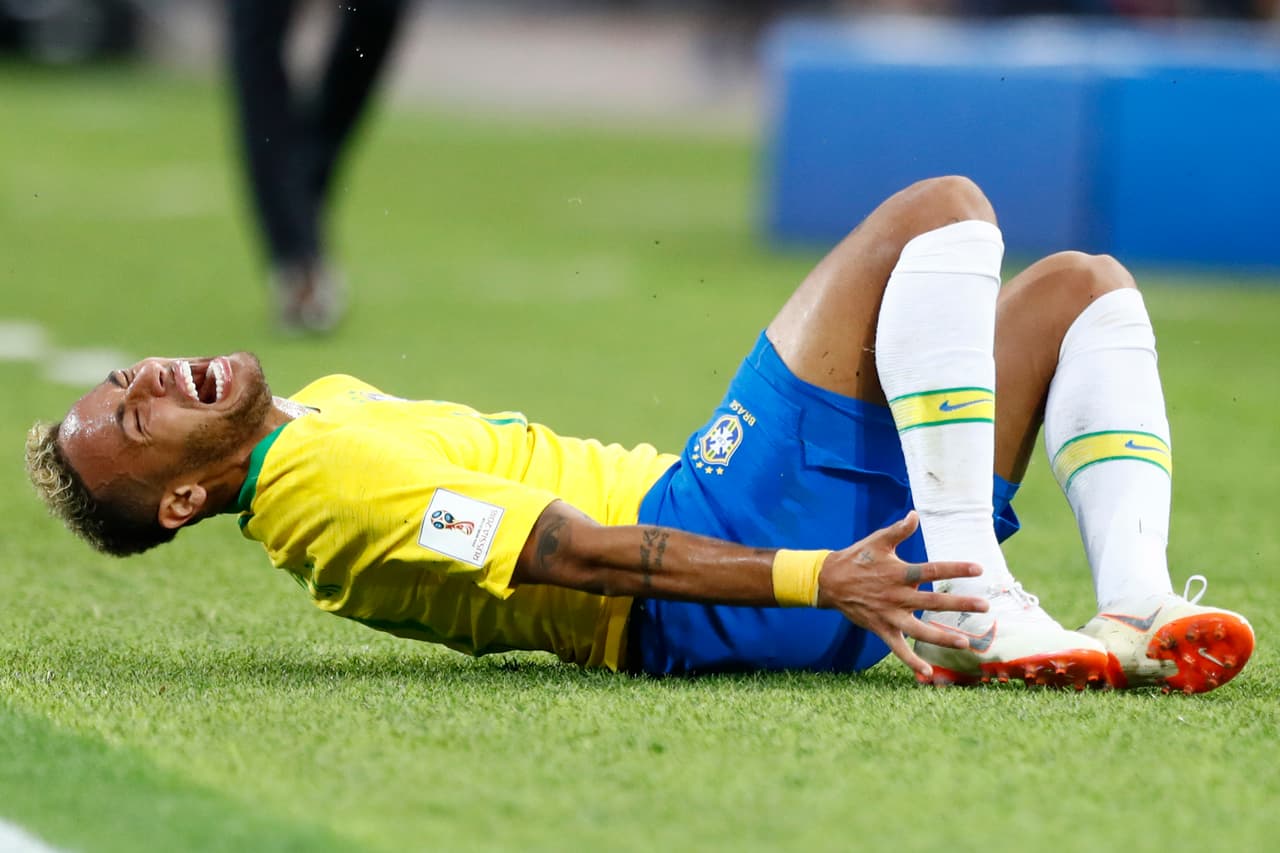 Brazil's Neymar grimaces in pain after a tackle by Serbia's Adem Ljajic during the group E match between Serbia and Brazil, at the 2018 soccer World Cup in the Spartak Stadium in Moscow, Russia, Wednesday, June 27, 2018. (AP Photo/Matthias Schrader)
