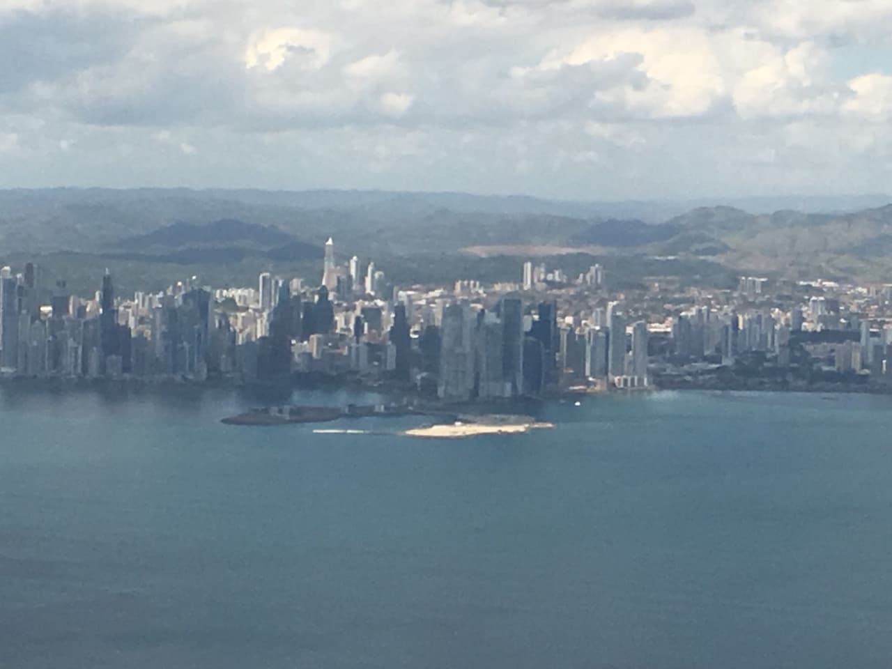 The Trump hotel's distinctive sail-like design can be seen (just right of center) from the air as airplanes come in to land at Panama International Airport.