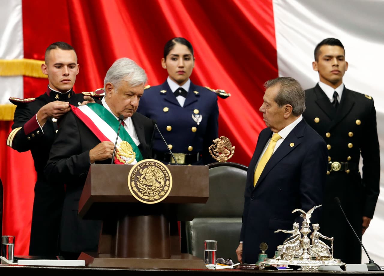 Mexico's new President Andres Manuel Lopez Obrador, left, receives the presidential sash as Porfirio Munoz Ledo, president of the Congress, right, looks on during the inaugural ceremony at the National Congress in Mexico City, Saturday, Dec. 1, 2018. (AP Photo/Eduardo Verdugo)