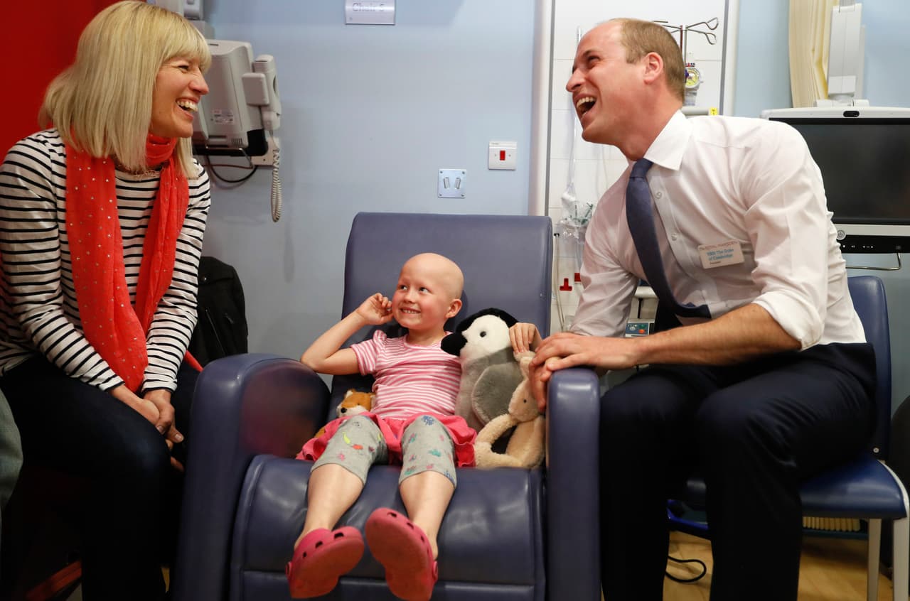 LONDON, UNITED KINGDOM - MAY 16: Prince William, Duke of Cambridge, right, meets patient Daisy Wood, 6, and her mother Katie during a visit to the Royal Marsden hospital on May 16, 2017 in Sutton, England. The Duke of Cambridge, President of the Royal Marsden NHS Foundation Trust, visited the hospital's facilities in Sutton. During the visit, which marks 10 years since His Royal Highness became President of the centre, The Duke accompanied staff as they went about their daily activities in treating and caring for patients. (Photo by Kirsty Wigglesworth - WPA Pool/Getty Images)