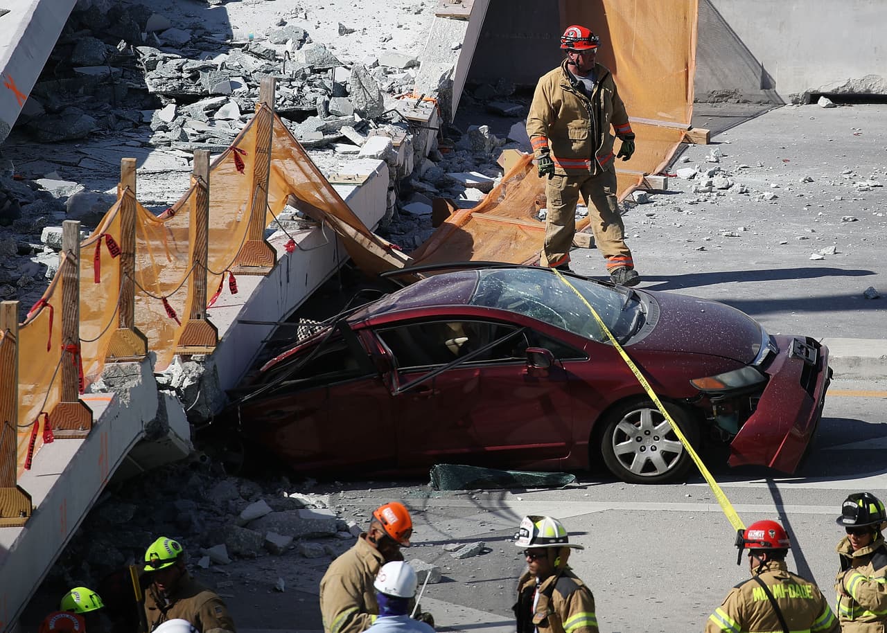 MIAMI, FL - MARCH 15: Miami-Dade Fire Rescue Department personel and other rescue units work at the scene where a pedestrian bridge collapsed a few days after it was built over southwest 8th street allowing people to bypass the busy street to reach Florida International University on March 15, 2018 in Miami, Florida. Reports indicate that there are an unknown number of fatalities as a result of the collapse, which crushed at least five cars. (Photo by Joe Raedle/Getty Images)