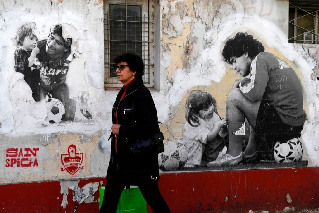 Una barda de La Paternal plasma el pasado para la eternidad. En los tiempos de Maradona con el Napoli, juega con su hija Dalma.