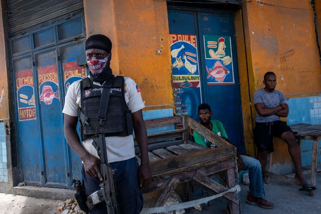 A Haitian National Police officer stands guard close to the gang controlled area of Morne A Tuff during the third day of a general strike and lack of transportation, amid a fuel shortage in Port-au-Prince, Haiti, on October 27, 2021.