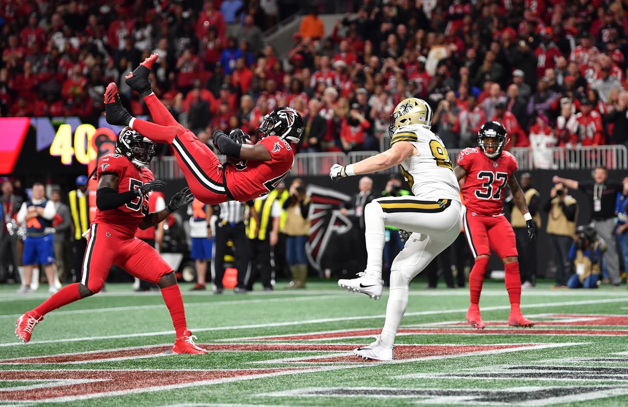 Atlanta Falcons middle linebacker Deion Jones (45) intercepts a ball in the end zone ahead of New Orleans Saints tight end Josh Hill (89) during the second half of an NFL football game, Thursday, Dec. 7, 2017, in Atlanta. (AP Photo/Danny Karnik)