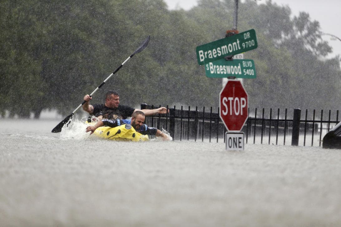 Residents take to a kayak to traverse flood waters in Houston. AP