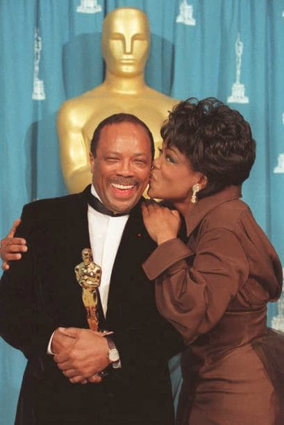 Besando a Quincy Jones, quien recibió un Oscar en 1995.