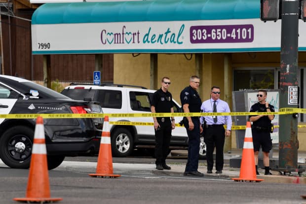 Law enforcement officials confer outside the Children's Dentistry office near 80th Ave. and Sheridan Blvd. in Westminster, Colorado on Thursday afternoon, June 14, 2018.