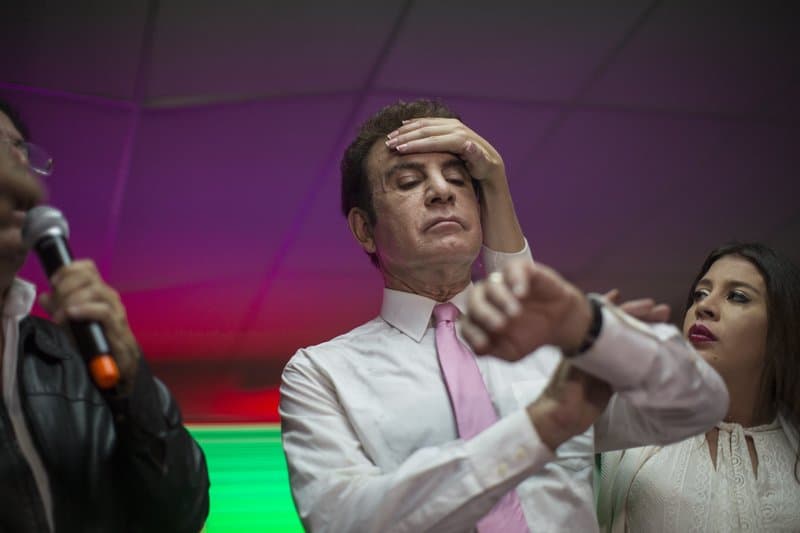 Libre Alliance candidate Salvador Nasralla looks at his watch as the election vote count in Honduras drags on for a fourth day on Wednesday. He says he won't recognize the official results due to suspicion of fraud.