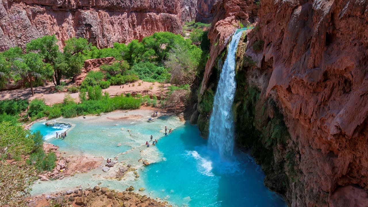 <b>Arizona.</b>
<br>
<br>Havasu Falls, las Cataratas Havasu, están situadas dentro de la Reserva Havasupai, que no forma parte del Parque Nacional del Gran Cañón. Los colores son increíbles:
<b>el rojo de los paredones de piedra contrastan con el azul del agua. </b>Para ingresar a las cataratas se requiere un permiso y una larga caminata.
<a href="https://www.visitarizona.com/like-a-local/a-guide-to-visiting-havasu-falls-the-right-way/" target="_blank">El sitio fue cerrado debido a la pandemia y se debe hacer reservas previas.</a>
<br>
<br>Havasu Falls se encuentra en la reserva Havasupai por lo que deberá comprar un permiso de la tribu Havasupai para acceder al área. Todas las visitas requieren al menos una reserva de una noche.
