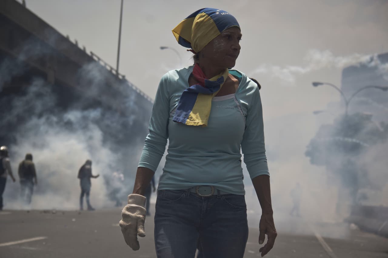A gloved right hand, in order to throw burning hot tear gas caninsters back at the police. April 19, 2017.