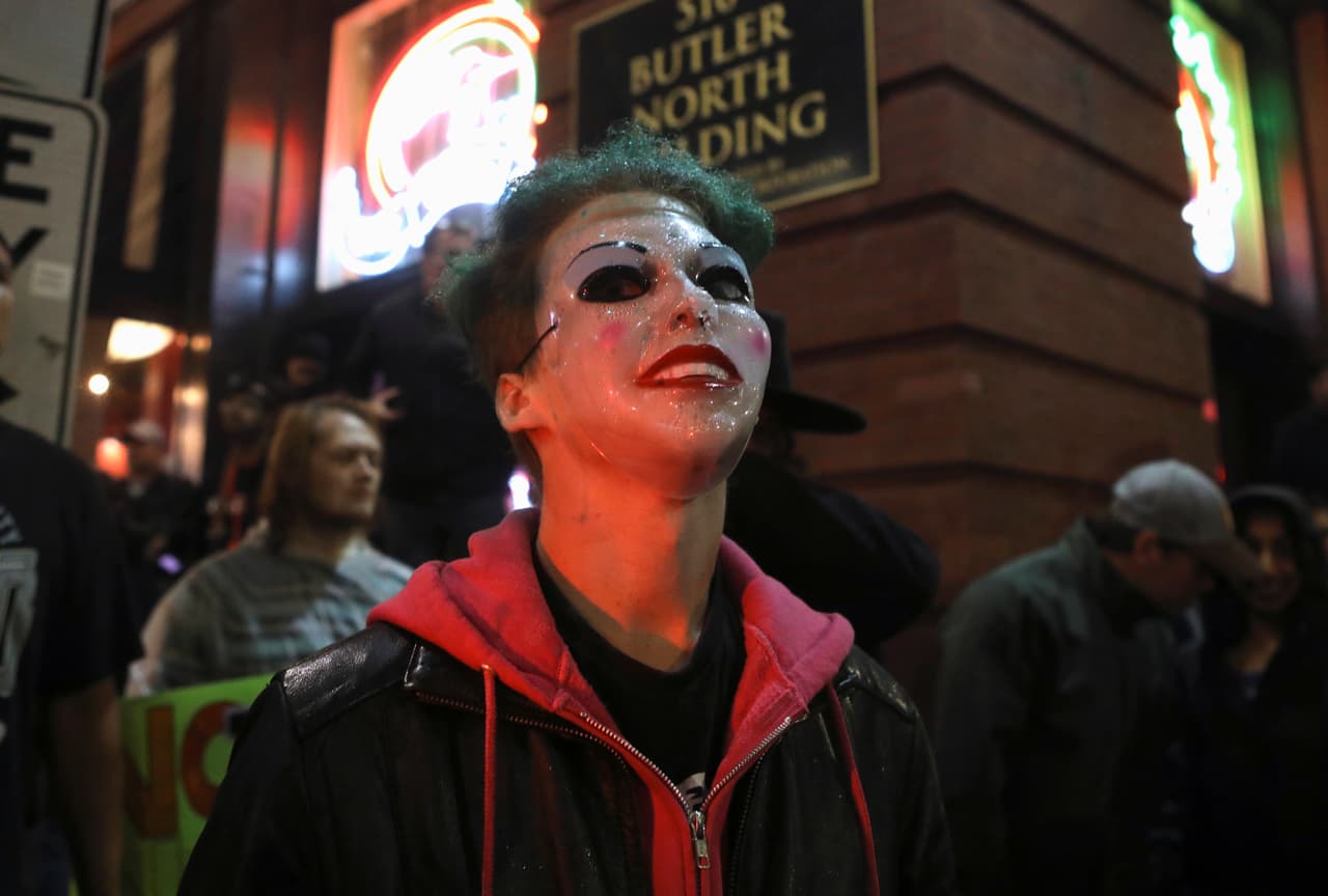 Un manifestante lleva puesta la máscara de 'El Joker' momentos antes de entrar al sitio donde se efectuó el mitin de Trump, el primero desde que se dio inicio al proceso de investigación para un probable juicio político.