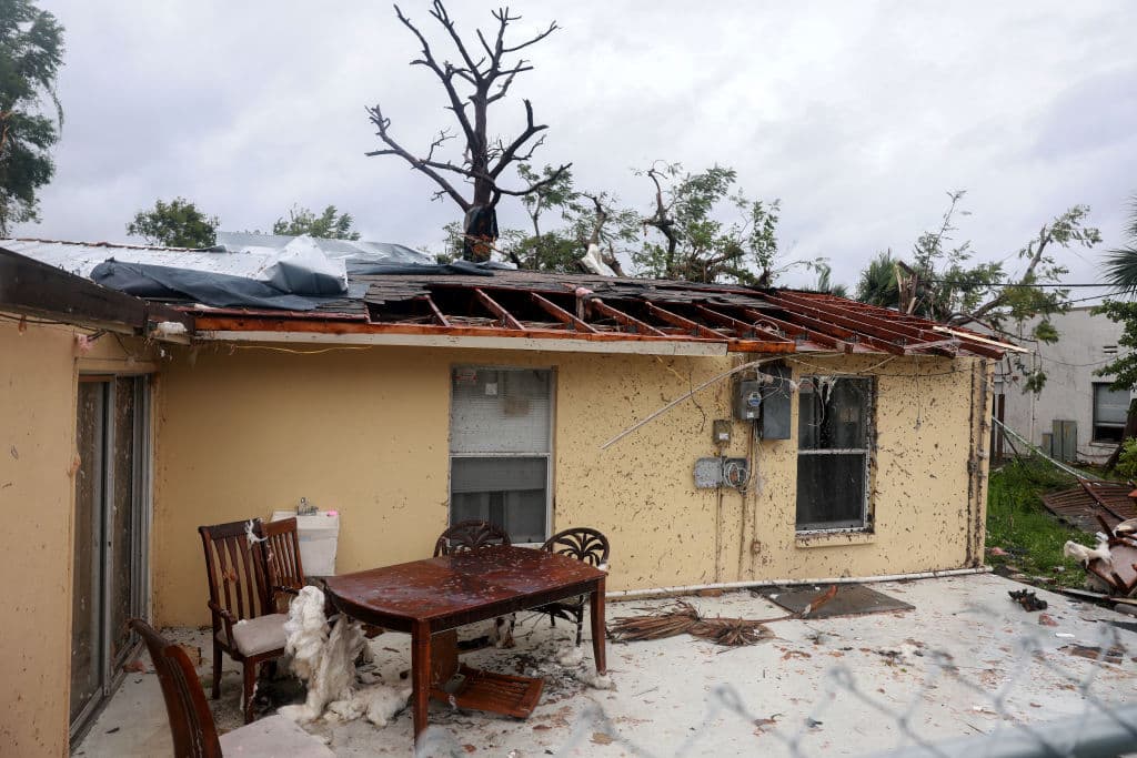FORT MYERS, FLORIDA - OCTOBER 09: A roof is torn off of a home after what appeared to be a tornado passed through the area before Hurricane Milton's arrival on October 09, 2024, in Fort Myers, Florida. People are preparing for the storm, which could be a Cat 3 when it makes landfall on Wednesday evening. (Photo by Joe Raedle/Getty Images)