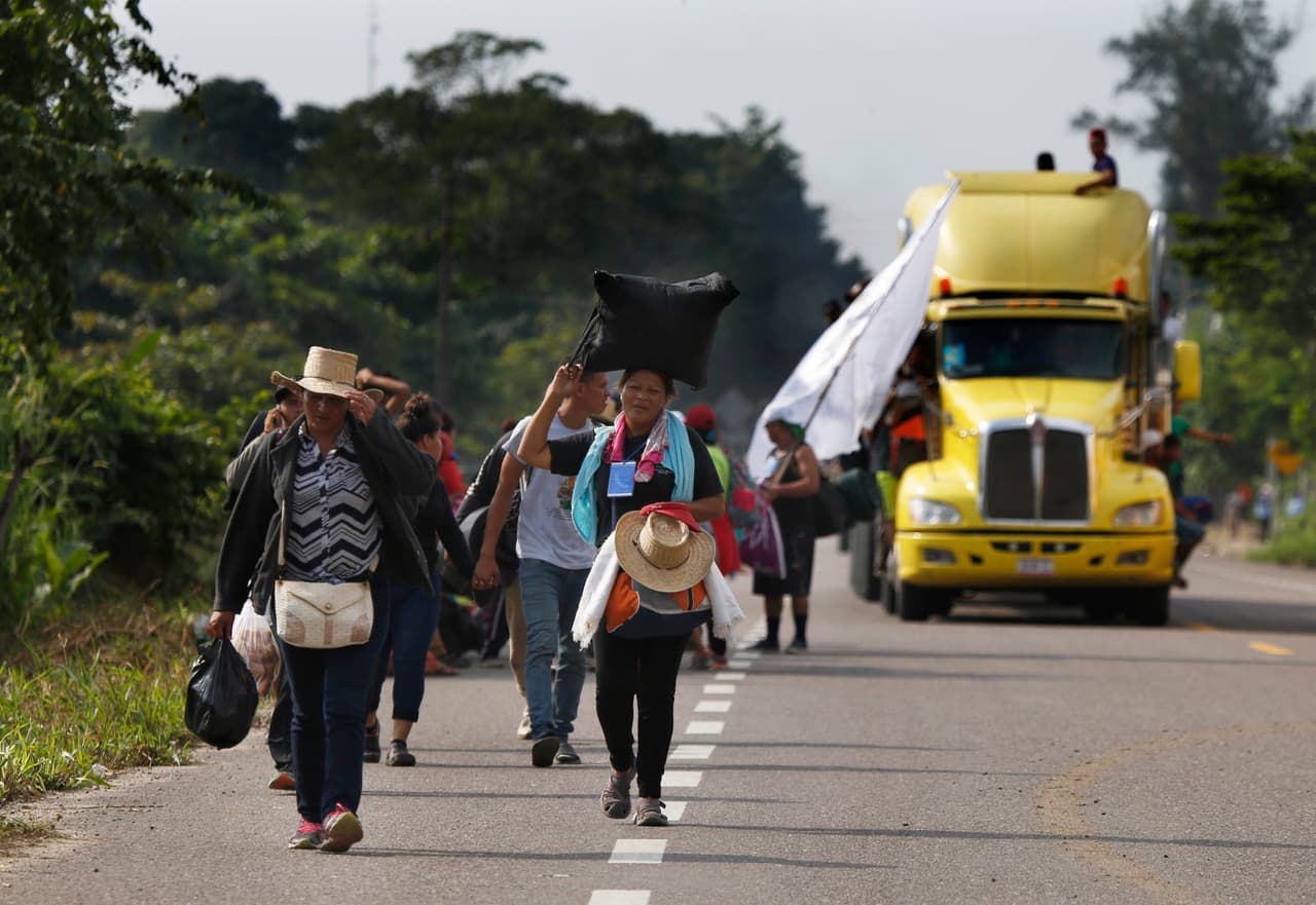 Central American migrants, part of the caravan hoping to reach the U.S. border, begin their morning trek, in Donaji, Oaxaca state, Mexico, Friday, Nov. 2, 2018. The migrants had already made a grueling 40-mile (65-kilometer) trek from Juchitan, Oaxaca, on Thursday, after they failed to get the bus transportation they had hoped for. But hitching rides allowed them to get to Donaji early, and some headed on to a town even further north, Sayula. (AP Photo/Marco Ugarte)