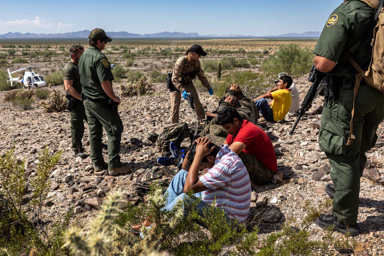 ORGAN PIPE NATIONAL MONUMENT, ARIZONA - SEPTEMBER 28: U.S. Customs and Border Protection (CBP) agents detain a group of immigrants after tracking them through rugged terrain on September 28, 2022 at the Organ Pipe National Monument, Arizona. U.S. immigration authorities made more than 2 million arrests along the U.S. southern border during the 2022 fiscal year, which ends September 30, the first time to reach that historic threshold. (Photo by John Moore/Getty Images)
