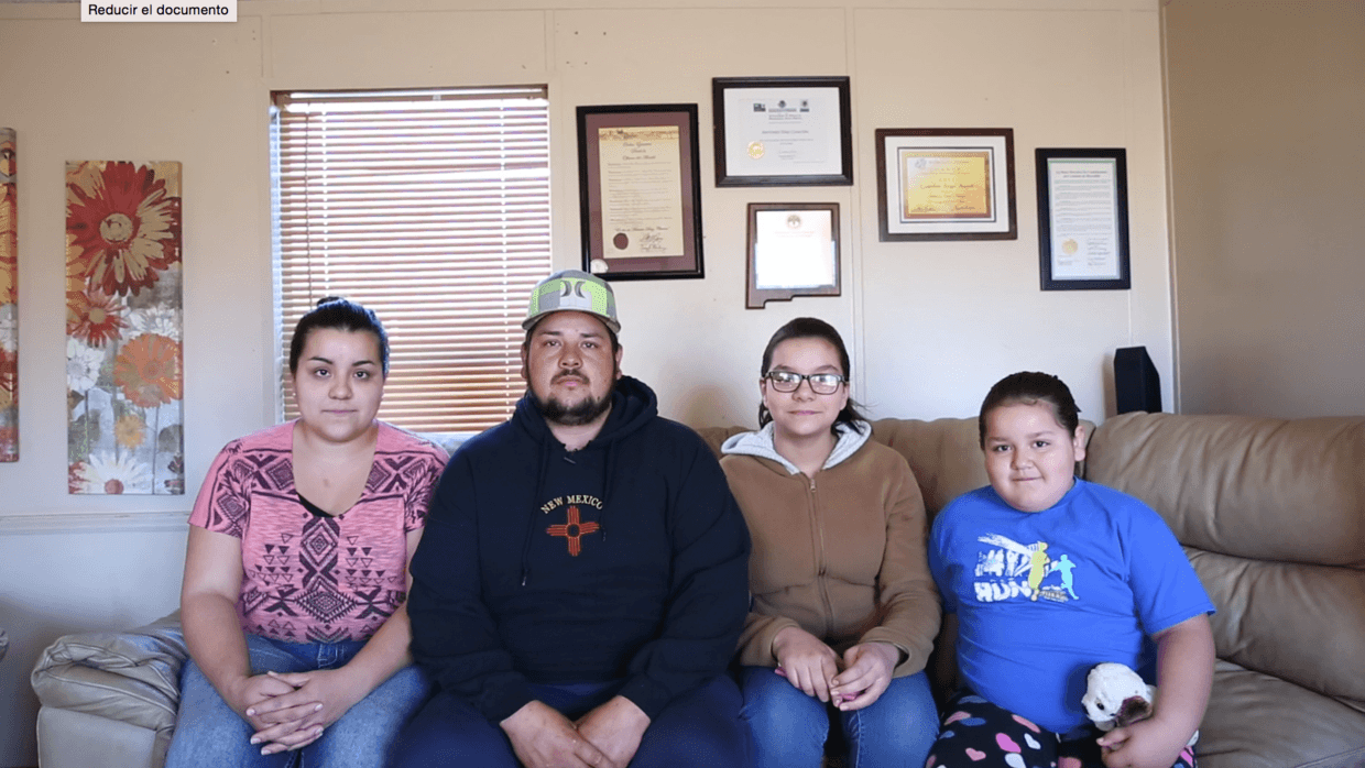 Antonio Díaz Chacón in the living room of his mobile home with his wife Martha and daughters Brisseida and Kasandra
