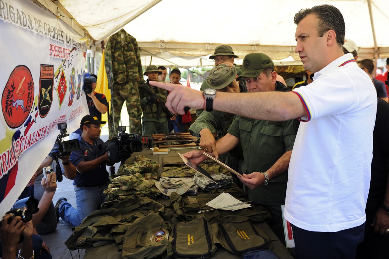 El Aissami shows items confiscated in a raid of a drug lab on the Colombian border in 2011.