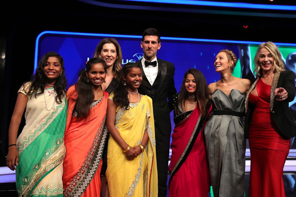 Novak Djokovic y Elena Djokovic, junto con Monica Seles y Nadia Comaneci, posan con los representantes de Yuwa Football Girls.