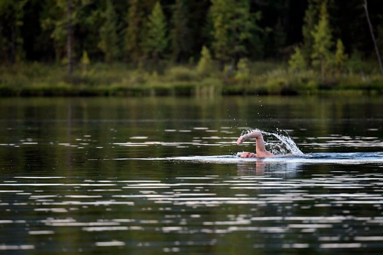 In this photo released by Kremlin press service on Saturday, Aug. 5, 2017, Russian President Vladimir Putin swims during a mini-break in the Siberian Tyva region, a few days ago. (Alexei Nikolsky/Sputnik, Kremlin Pool Photo via AP)