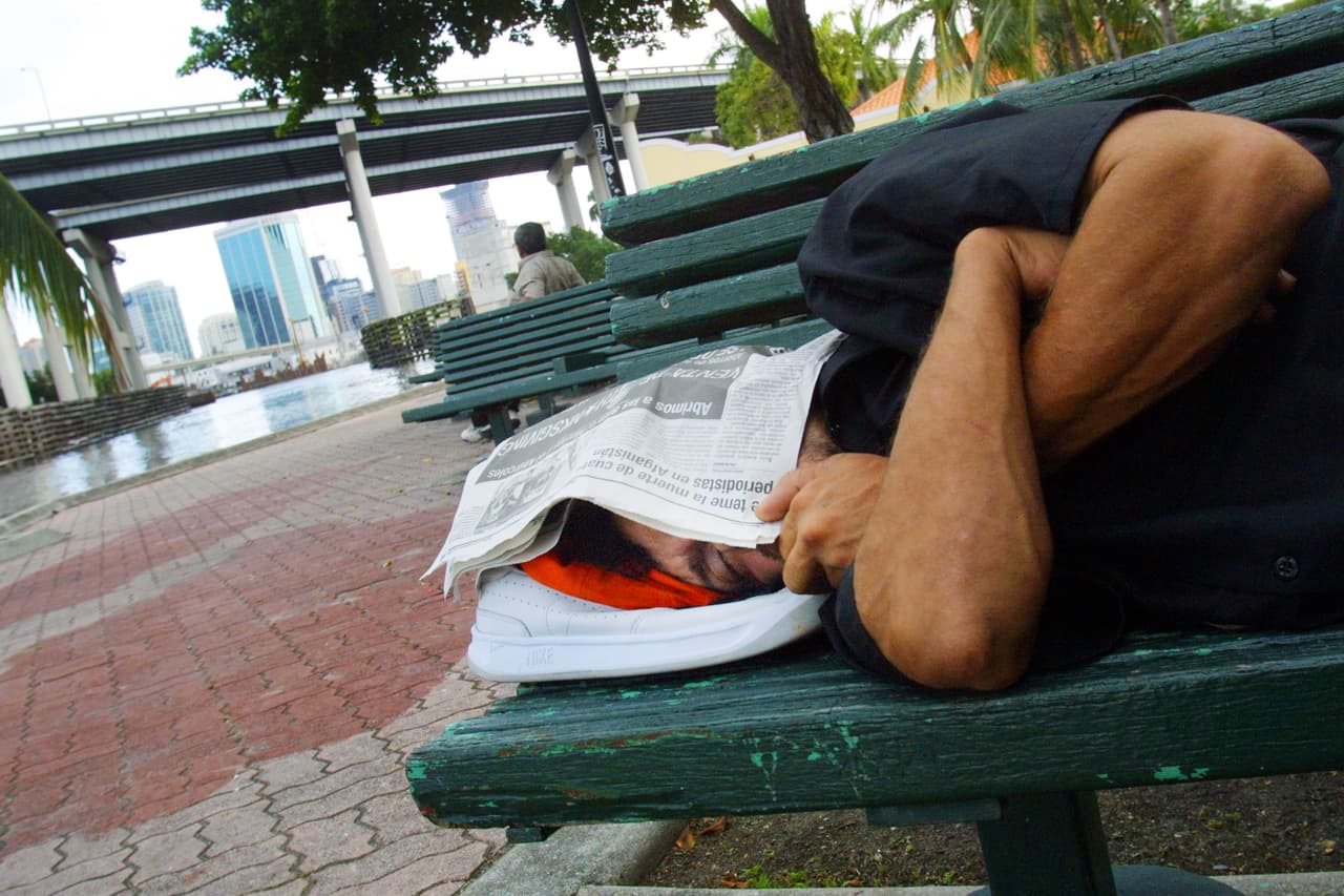 Según WalletHub,
<b>el estrés afecta a más de 100 millones de personas </b>en todo el territorio estadounidense principalmente por el
<b> dinero, </b>seguido por el
<b> trabajo, la familia y las relaciones</b>. En la foto se ve a un hombre durmiendo en un banco del parque en Miami, Florida. Casi un tercio de la población de la ciudad - el 32 por ciento de los residentes - vive en la pobreza, un porcentaje mayor que en cualquier otra ciudad de 250.000 o más habitantes.