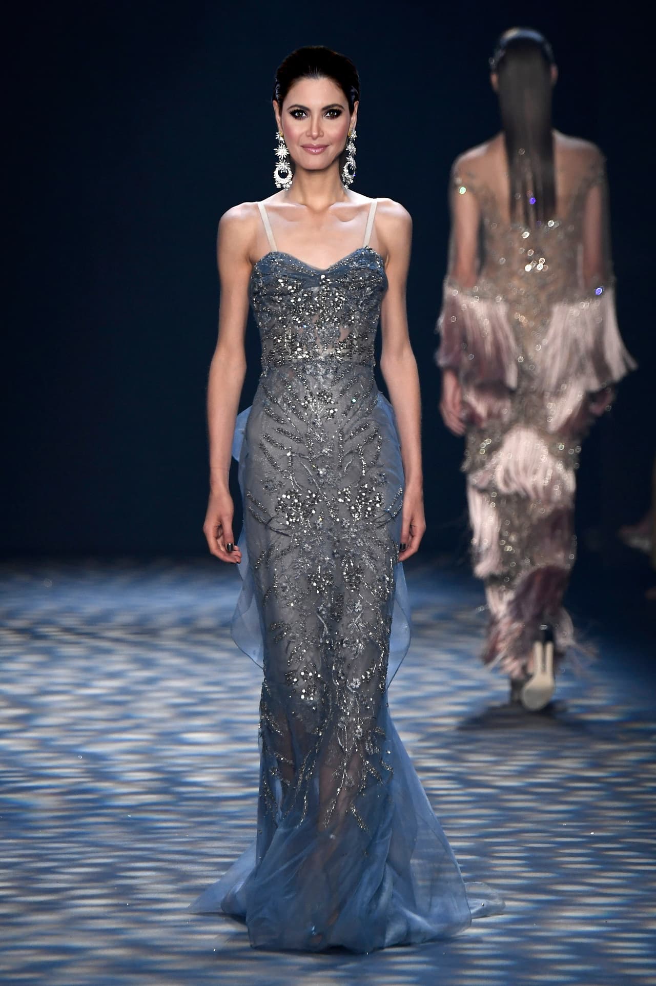 Sorprender en una alfombra roja, a veces no requiere mucho más que evocar el estilo brillante y de líneas simples de las divas del cine de los años 30. En tonos humos y platas, Chiquinquirá Delgado podría lucir un simple vestido de brocados y pedrería para robarle a todo el mundo de la música latina el aliento.