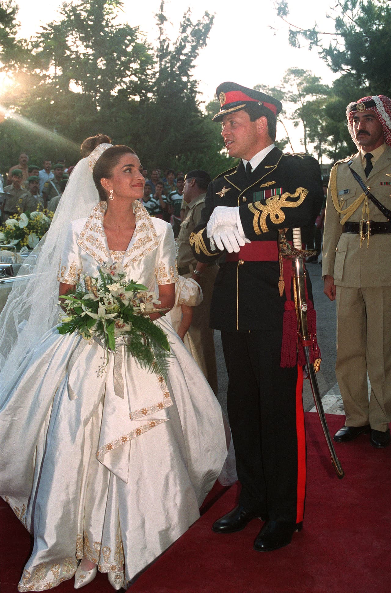 <b>1993 - Rania and King Abdallah of Jordan </b>
<br>
<a href="http://royalcentral.co.uk/blogs/history/looking-back-at-the-wedding-of-king-abdullah-ii-and-queen-rania-83358">22 years old</a> Rania chose English designer Bruce Oldfield for her gown, with a lapelled jacket and short gold-embroidered sleeves, with a belt over a voluminous skirt. She wore her hair very high, with no tiara.