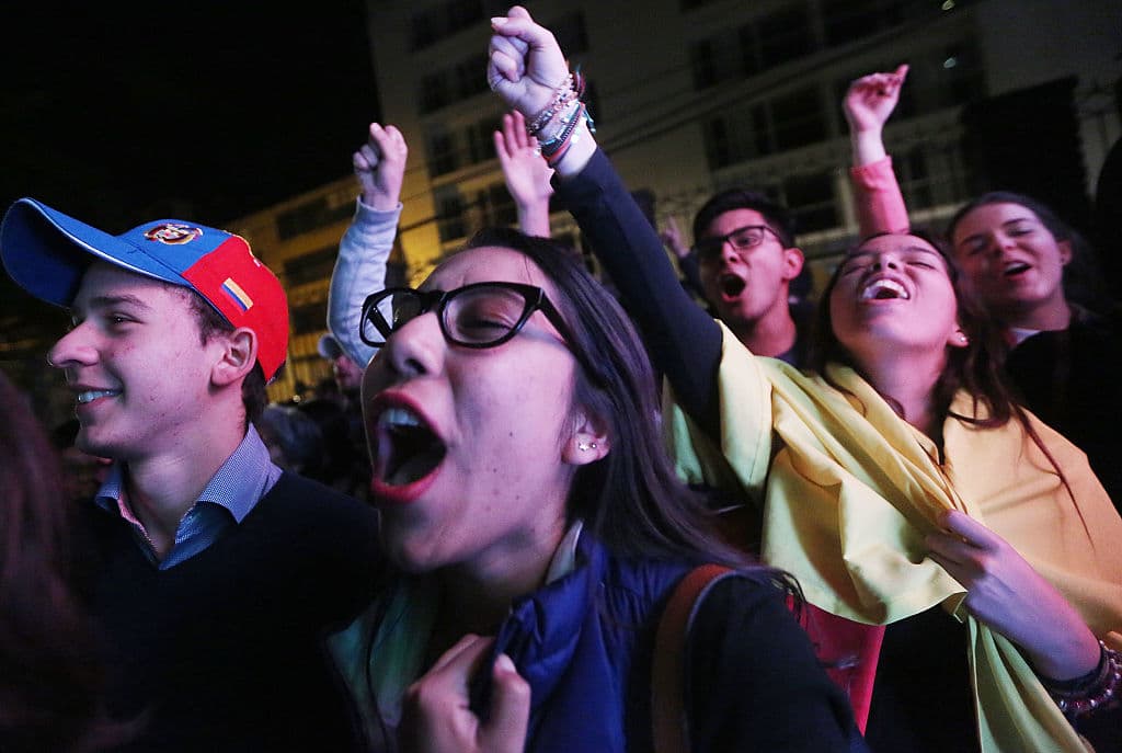 BOGOTA, COLOMBIA - OCTOBER 02: 'No' supporters celebrate at a rally following their victory in the referendum on a peace accord to end the 52-year-old guerrilla war between the FARC and the state on October 2, 2016 in Bogota, Colombia. The guerrilla war is the longest-running armed conflict in the Americas and has left 220,000 dead. The plan called for a disarmament and re-integration of most of the estimated 7,000 FARC fighters. Colombians have voted to reject the peace deal in a very close vote. (Photo by Mario Tama/Getty Images)