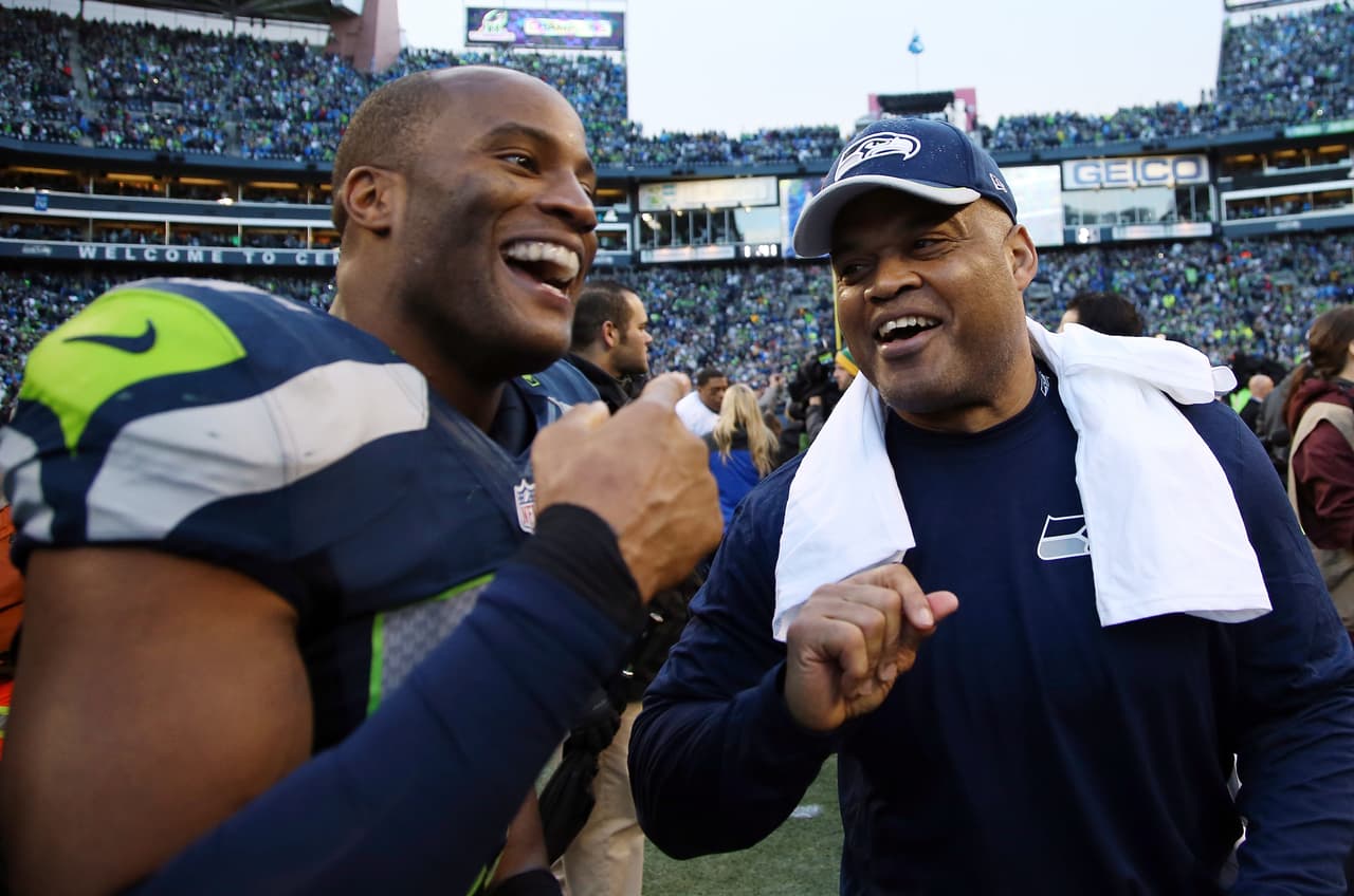 Seattle Seahawks outside linebacker Mike Morgan (57) celebrates with Seattle Seahawks linebackers coach Ken Norton, Jr. after winning the NFL week 20 NFC Championship football game against the Green Bay Packers on Sunday, Jan. 18, 2015 in Seattle. The Seahawks won the game 28-22 in overtime. (AP Photo/Paul Spinelli)