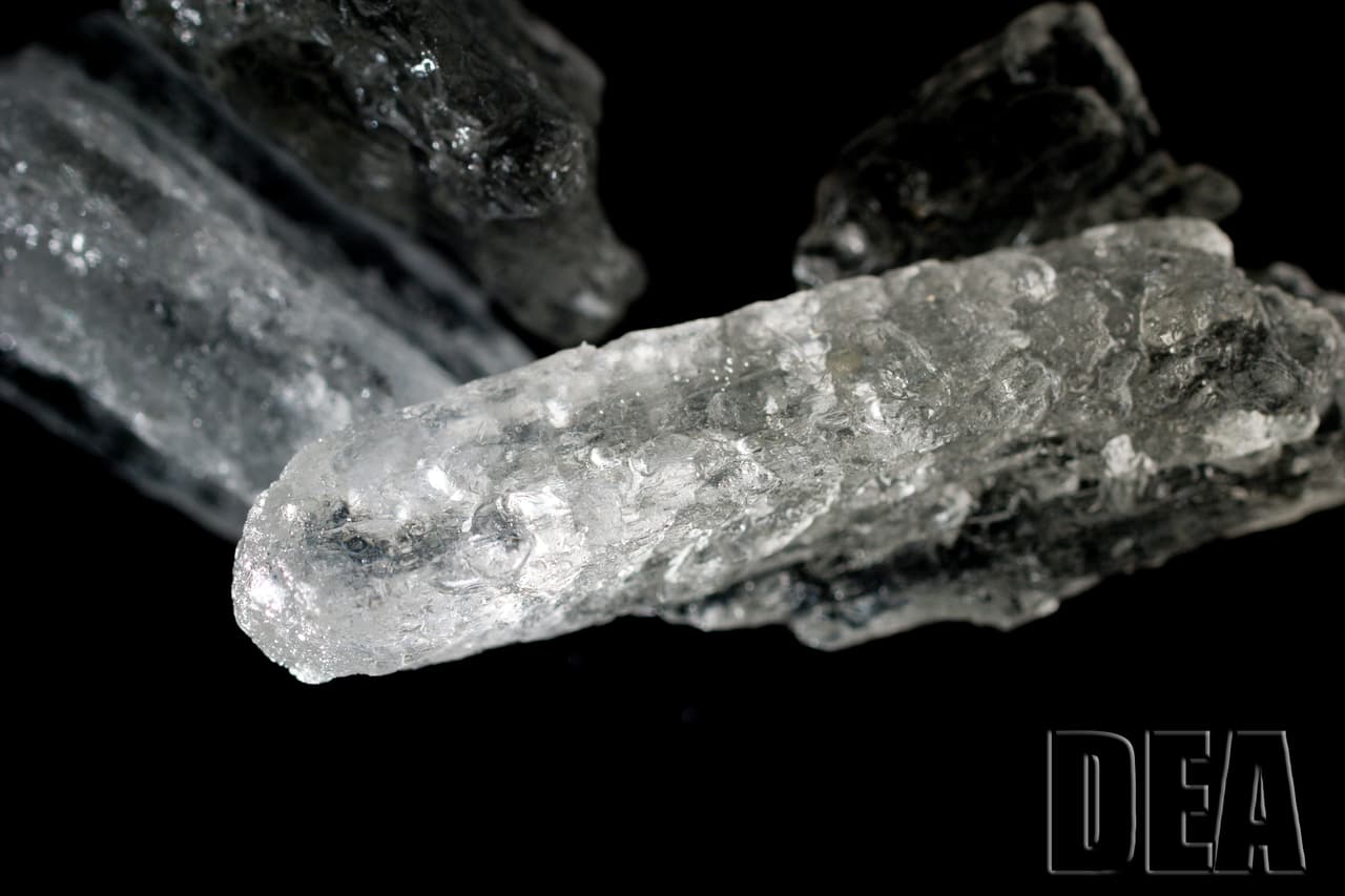 <h3 class="cms-H3-H3">Metanfetamina</h3>
<br>
<br>Se trata de una droga estimulante que 
<b>generalmente se usa como un polvo blanco de sabor amargo o una forma de pastilla.</b> Una forma de esta droga se parece a fragmentos de vidrio o rocas blancas azuladas brillantes. 
<br>
<br>Algunos nombres más comunes para esta droga son Crank, Chalk, Crystal, Dunk, Gak, Ice, Meth, Pookie, Quartz, Rocket Fuel, Scooby Snax, Speed, Trash. 
<br>
<br>De acuerdo con el NIH, 
<a href="https://www.drugabuse.gov/drug-topics/commonly-used-drugs-charts#methamphetamine" target="_blank">algunas posibles afectaciones a la salud en un corto plazo</a> podrían ser: aumento de la actividad física, disminución del apetito, incremento de la respiración, frecuencia cardíaca, presión arterial, temperatura y arritmia. 
<br>
<br>A largo plazo, el abuso de esta droga podría causar ansiedad, confusión, insomnio, problemas de humor, comportamiento violento, paranoia, alucinaciones, delirios, pérdida de peso, problemas dentales graves y picazón intensa que provoca llagas en la piel por rascarse.