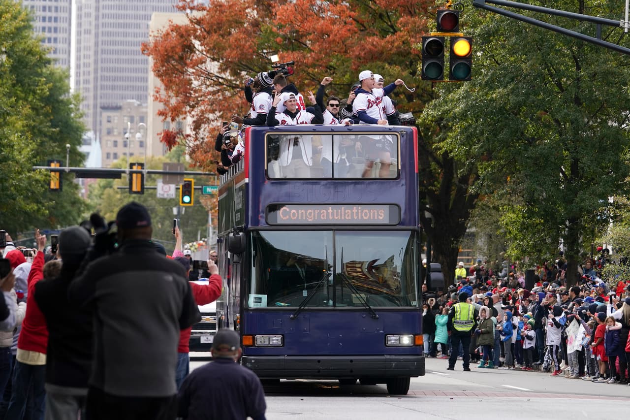 Atlanta Braves players celebrate the team's victory during a victory parade, Friday, Nov. 5, 2021, in Atlanta. The Braves beat the Houston Astros 7-0 in Game 6 on Tuesday to win their first World Series baseball title in 26 years. (AP Photo/Brynn Anderson)