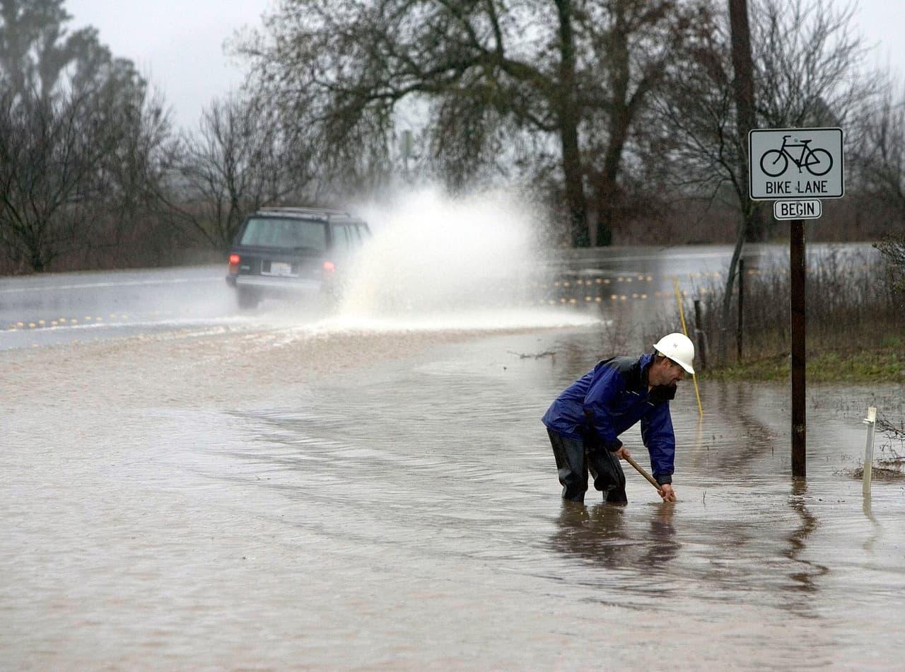 NAPA, CA - DECEMBER 31: Workers clean out a drain after a storm left much of downtown under water on December 31, 2005 in Napa, California. A powerful winter storm dumped record amounts of rain and sent rivers and creeks overflowing into many cities and towns in northern California. Forecasters are warning of another storm tomorrow that could set off more flooding and landslides. (Photo by David Paul Morris/Getty Images)