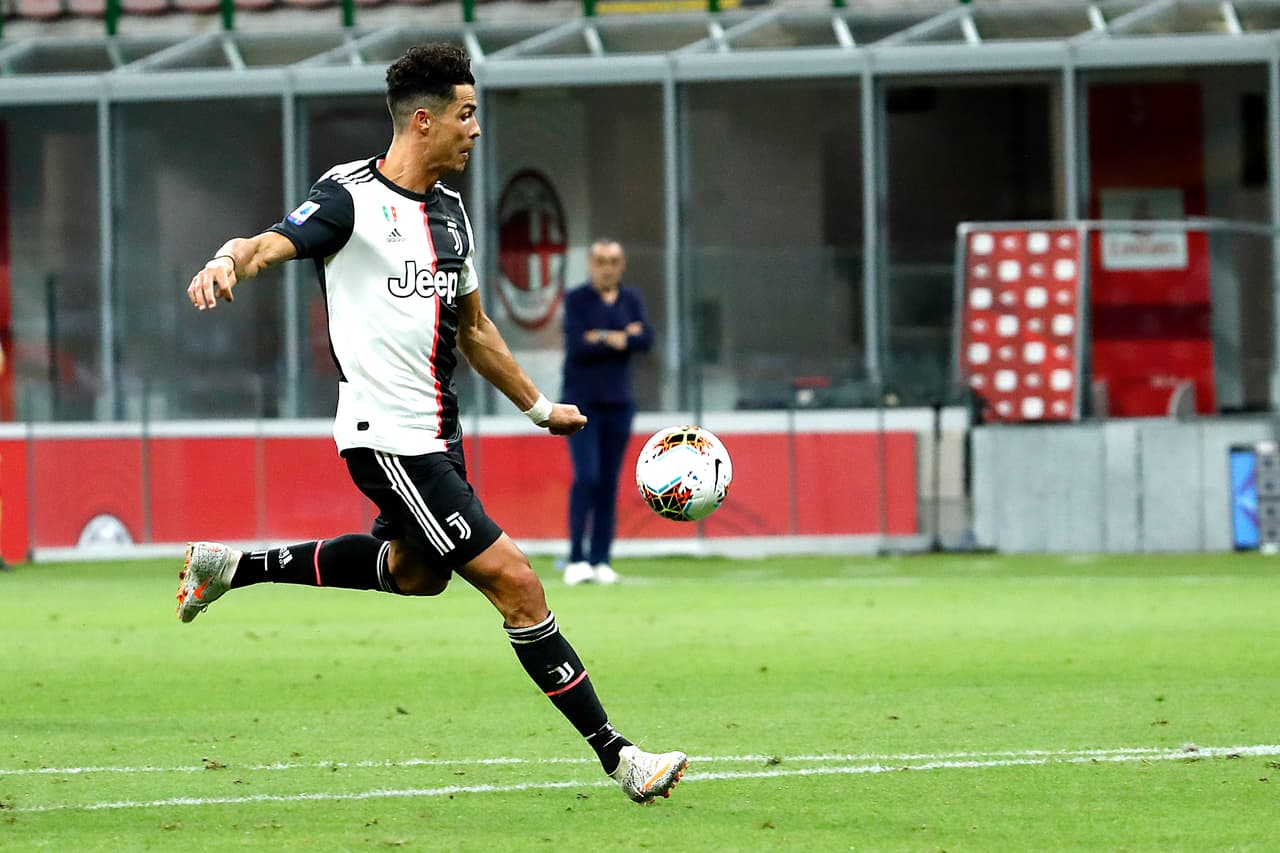 Juventus' Cristiano Ronaldo scoring against AC Milan during the Serie A soccer match between AC Milan and Juventus at the San Siro stadium, in Milan, Italy, Tuesday, July 7, 2020. (AP Photo/Antonio Calanni)