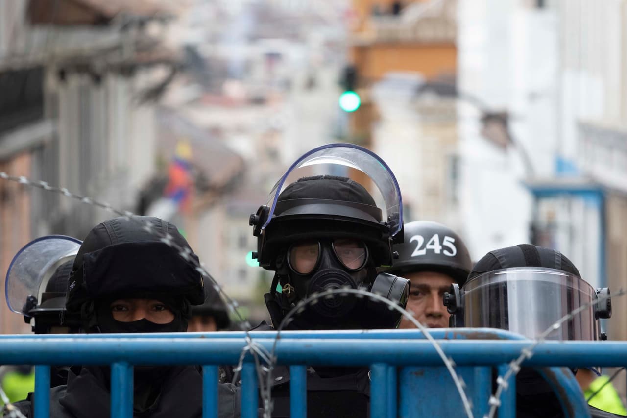 Oficiales de policía con marcas hacen guardia detrás de las vallas cerca del Palacio Presidencial. Más de 500 personas han sido arrestadas.