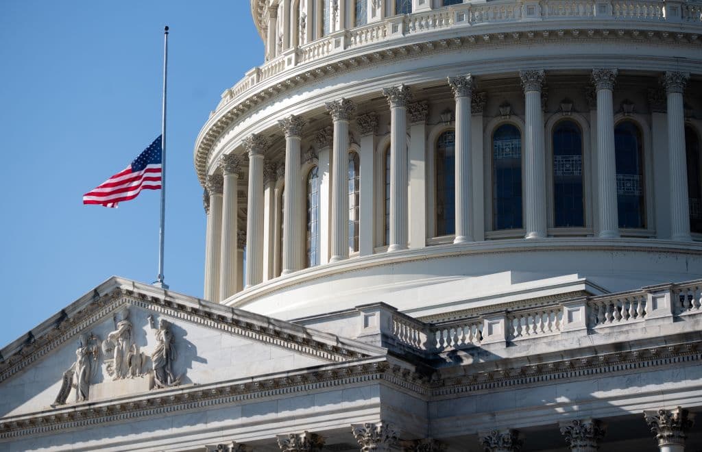 The outside of the US Capitol is seen with a US flag at half-staff in Washington, DC, January 12, 2021.