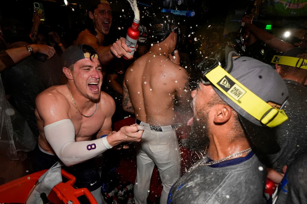 Los Angeles Dodgers third base Kiké Hernández and Teoscar Hernández celebrate their win against the New York Mets in Game 6 of a baseball NL Championship Series, Sunday, Oct. 20, 2024, in Los Angeles. The Dodgers will face the New York Yankees in the World Series. (AP Photo/Ashley Landis)